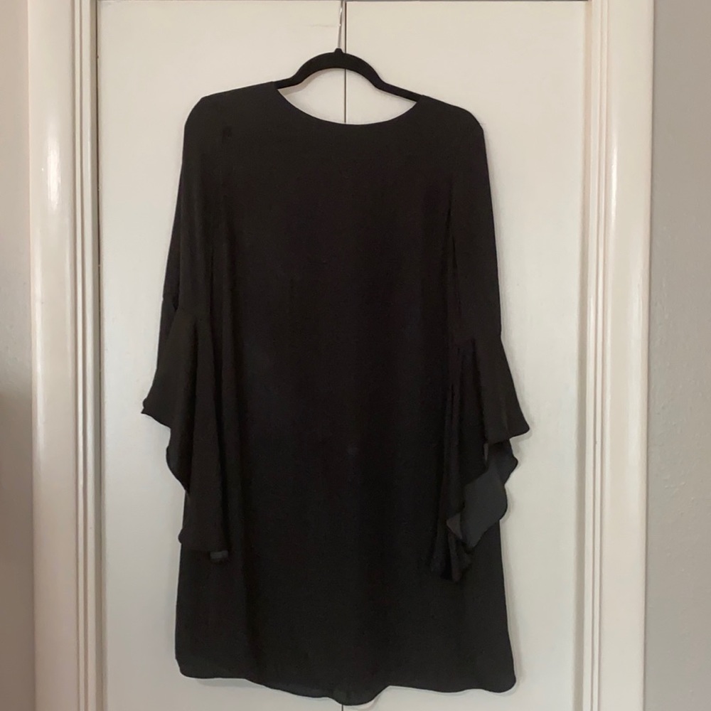 Black knee length dress with dramatic sleeves